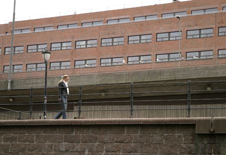 A young woman is walking along a river in a city, Oslo, Norway.の写真素材