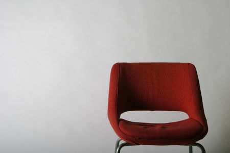 A simple red chair on a white backgroundの写真素材