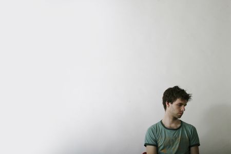 A male is sitting aloneの写真素材