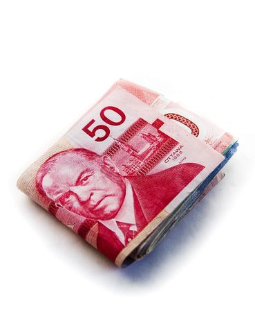 Large fold of Canadian money with the $50 canadian bill on the topの写真素材