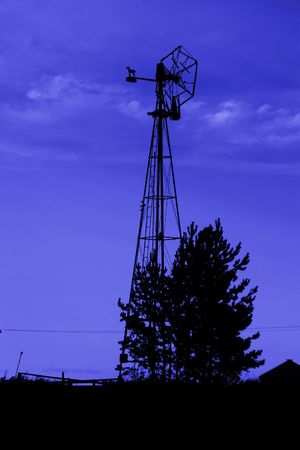 An old windmill on the prairie with deep blue skyの写真素材