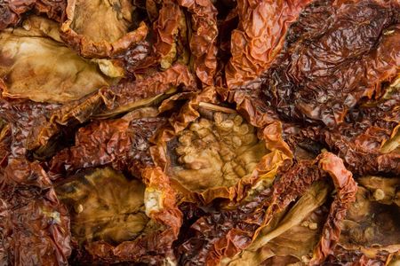 Bulk dried tomatoes over whiteの写真素材