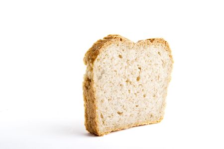 A single slice of homemade bread on a white background.