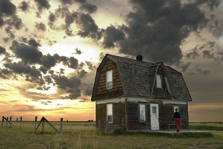 Prairie Landscape with an old house and personの写真素材