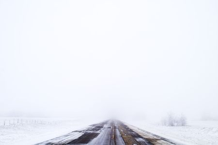 Prairie highway on a foggy day.