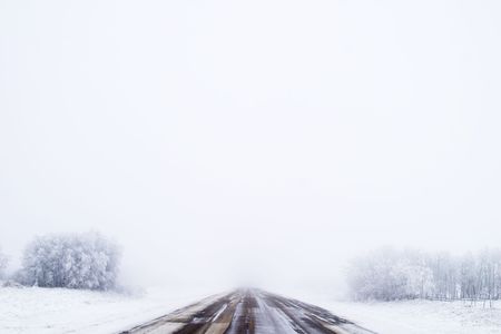 Prairie highway on a foggy day.の写真素材