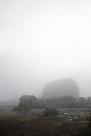 Abandoned farmyard engulfed in fog.の写真素材