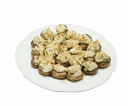 A plate of stuffed mushrooms isolated on white with .の写真素材