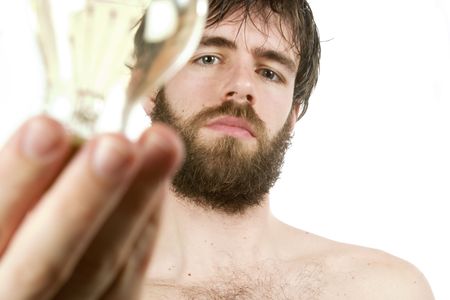 A concept image displaying a young bearded male, holding a light bulb. Fresh New Idea.の写真素材