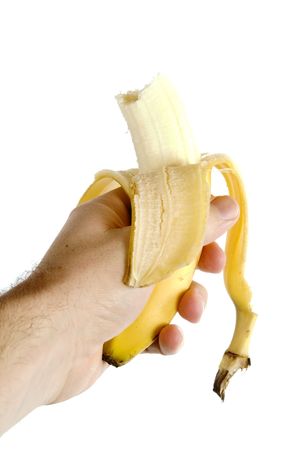 A half eaten banana being held in a hand. Isolated on white with .の写真素材