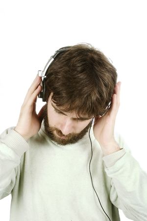 A young male with a beard listening to music on headphones. Isolated on white with .の写真素材