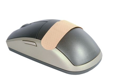 A cordless mouse with a adhesive bandage on it.  Isolated on white withclipping path.の写真素材