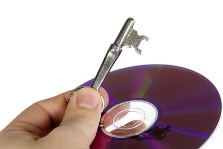 A skeleton key and a computer disk being held by a males hand, isolated on white