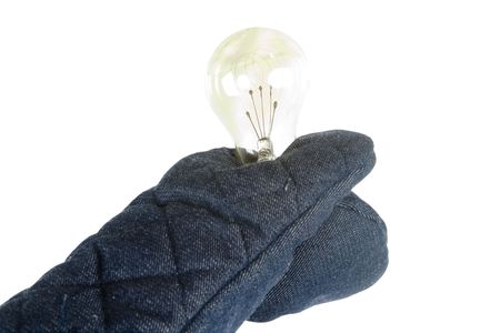 A light bulb being held by an oven mitt.  Isolated on whiteの写真素材