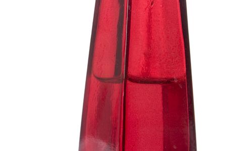 A red glass bottle isolated on white.の写真素材