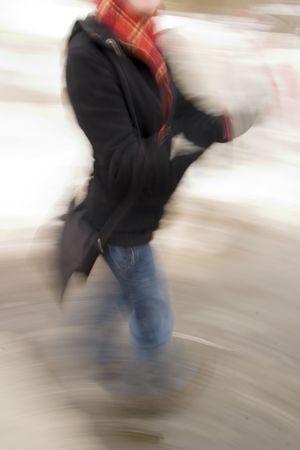 A motion blur abstract of a person walking in a hurry, a late rushing concept image.の写真素材