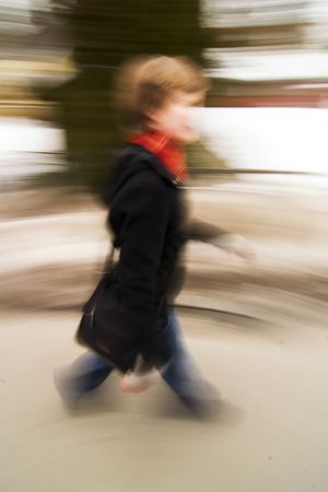 A motion blur abstract of a person walking in a hurry, a late rushing concept image.の写真素材