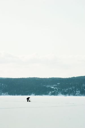 A person Ice fishing on the oslo fjord in early March.の写真素材