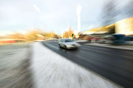 Zoom blur of a speeding car on a urban roadの写真素材