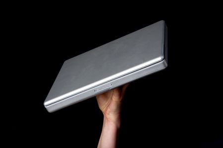 A handholding a small laptop computer with a blank screen.の写真素材