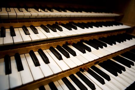 An old pipe organ keyboard in a church