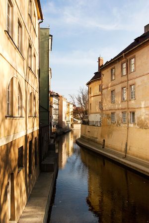 A small river flowing through the old town area of Prague, Czech Republic.の写真素材