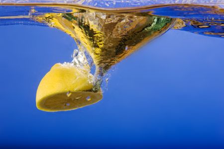 A lemon with a blue background in waterの写真素材