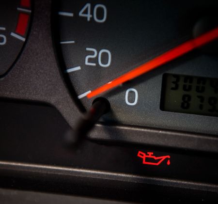 Low Oil sign in a car that is lit red