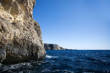 A cave in the ocean with a ciff openingの写真素材