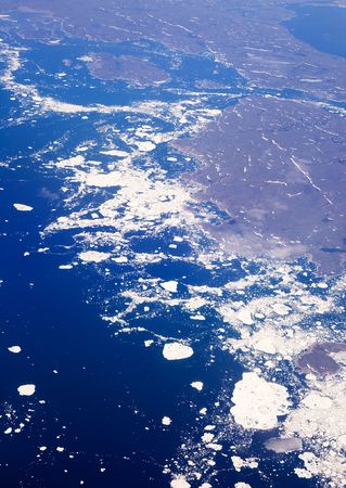 An aerial view of a melting glacier in the ocean.