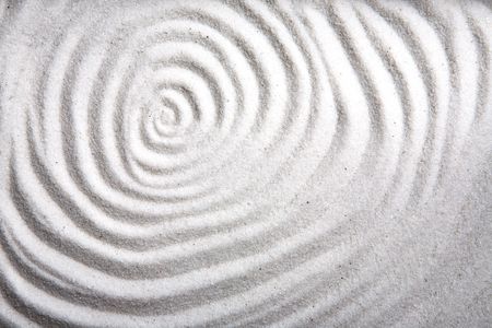 A background patter of a swirl in white sandの写真素材