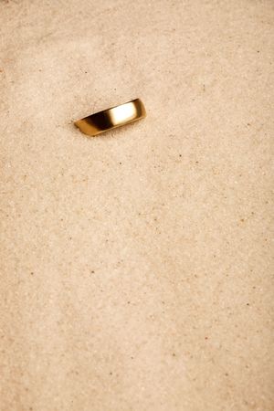 A wedding ring buried in the sand - lostの写真素材