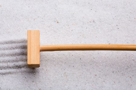 A small rake, creating a design in a zen gardenの写真素材