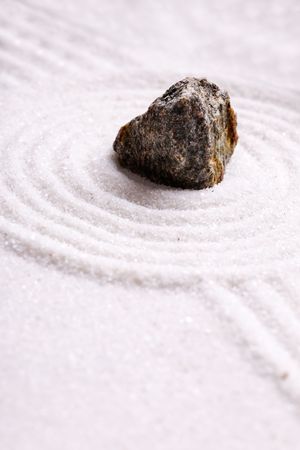 A rock in sand - zen rock garden
