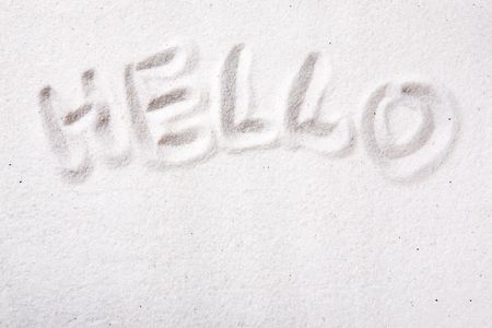 Hello written in beautiful white sandの写真素材