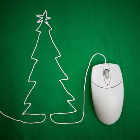 Online christmas shopping concept, mouse on green background with christmas treeの写真素材