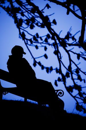 A person sitting alone on a benchの写真素材