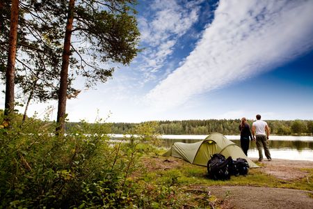 A couple camping on a lake landscapeの写真素材