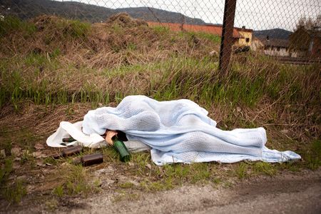A homeless drunk person sleeping in the ditchの写真素材