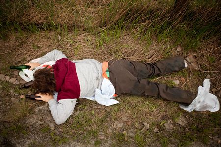 A drunk homeless man laying the ditchの写真素材