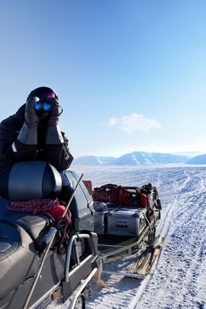 A winter adventure guide securing the area for dangerous wildlifeの写真素材