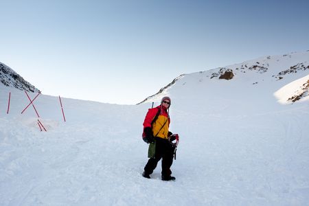 A female mountaineer on a snow filled slope, Svalbard, Norwayの写真素材