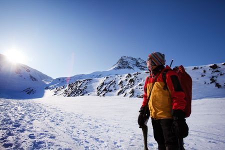 A female mountaineer against a winter mountain landscapeの写真素材