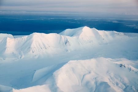 A mountain landscape filled with snow, Svalbard, Norwayの写真素材
