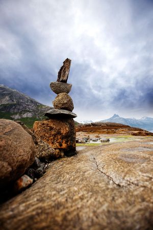 A rock stacking sculpture statue on a Norwegian landscape