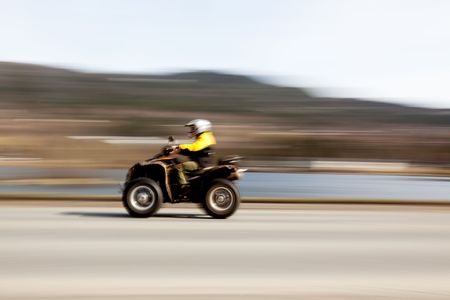 A quad on a road with motion blurの写真素材