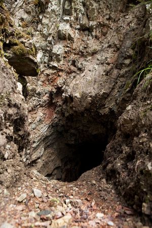 A mysterious rock cave in the side of a hill