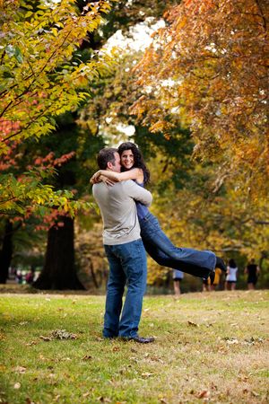 A man giving a bear hug to a woman の写真素材