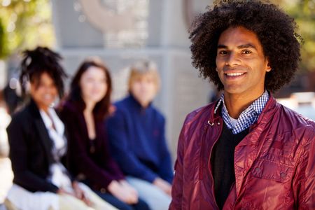 Group of four people of different ethnicities with one man as focus of image. Horizontally framed shot.の写真素材