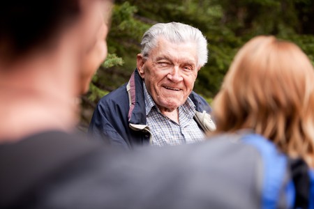 A grandfather talking a group of grandchildrenの写真素材